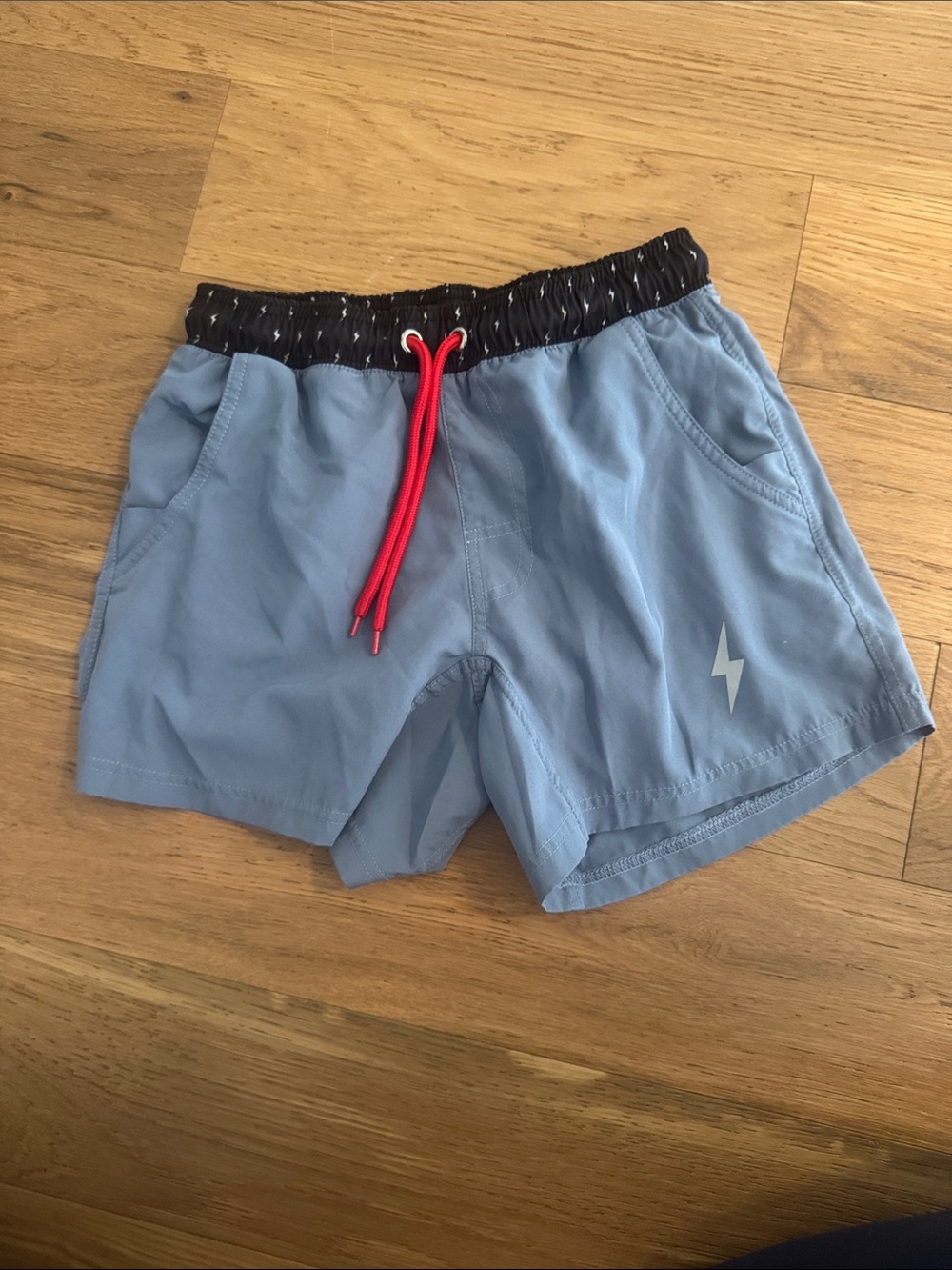 Light Blue Athletic Shorts with Black Waistband and Red Drawcord